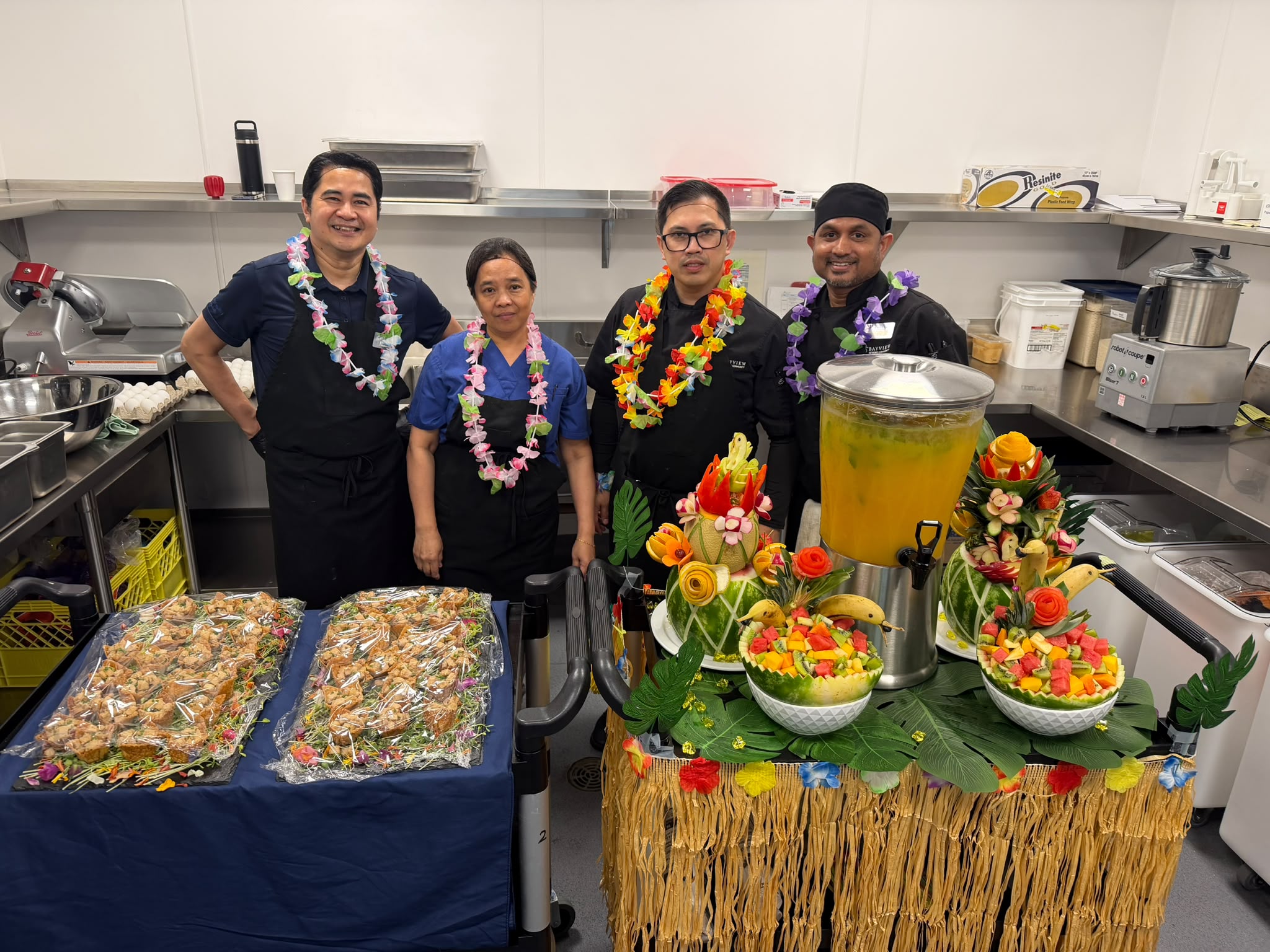 long-term-care-white-rock-bayview-hawaiian-day-WhatsApp Image 2026-07-21 at 13.13.32 Bayview culinary team preparing a Hawaiian-themed dining experience for residents in White Rock, BC